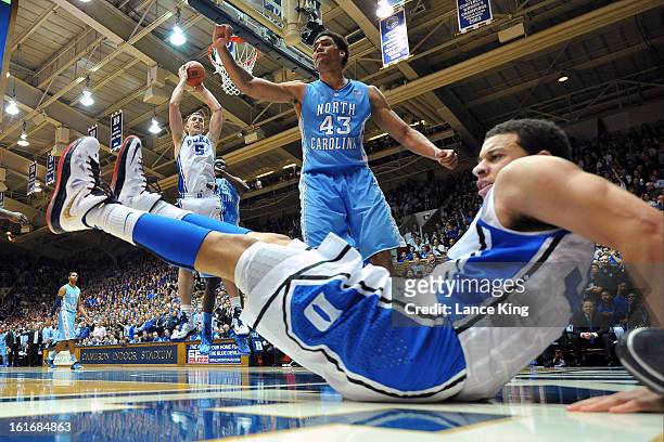 Seth Curry of the Duke Blue Devils falls to the floor following a foul by James Michael McAdoo of the North Carolina Tar Heels at Cameron Indoor...