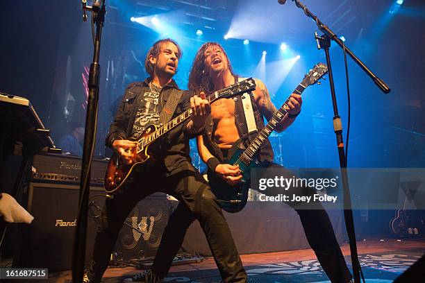 Guitarists Luca Princiotta and Bas Maas of DORO performs in concert at Mojoes on February 13, 2013 in Joliet, Illinois.