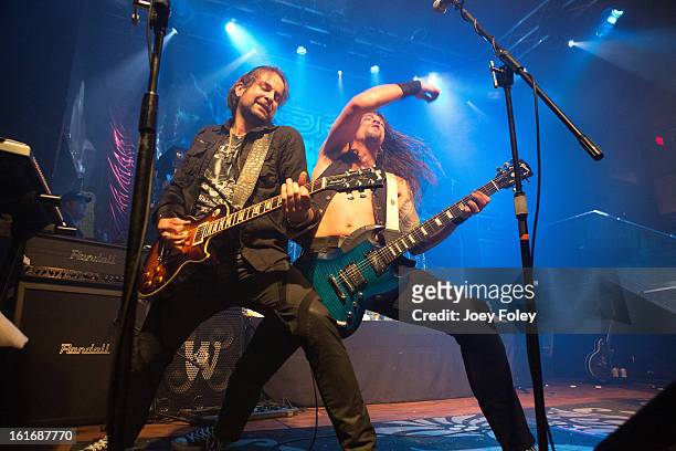 Guitarists Luca Princiotta and Bas Maas of DORO performs in concert at Mojoes on February 13, 2013 in Joliet, Illinois.