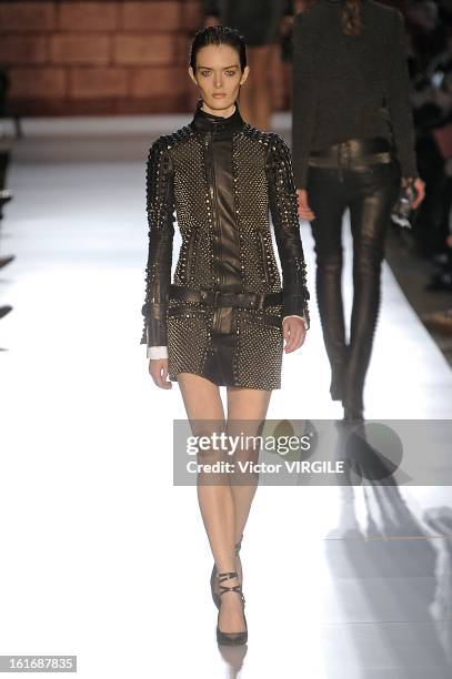 Model walks the runway at the Diesel Black Gold Ready to Wear Fall/Winter 2013-2014 fashion show during Mercedes-Benz Fashion Week at Pier 57 on...