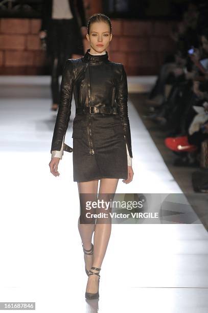 Model walks the runway at the Diesel Black Gold Ready to Wear Fall/Winter 2013-2014 fashion show during Mercedes-Benz Fashion Week at Pier 57 on...