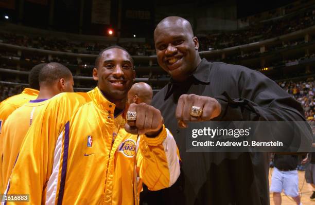 Kobe Bryant and Shaquille O'Neal of the Los Angeles Lakers show off their NBA Championship rings prior to the season opener against the San Antonio...