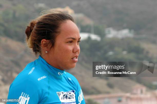 Hawaiian surfer Melanie Bartels checks out the surf with the hills of Malibu behind her at the 2005 Rip Curl Malibu Pro Surfing Contest wearing a...