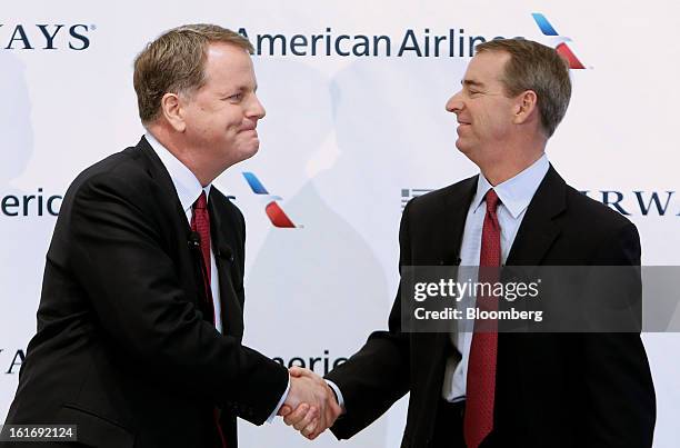 Doug Parker, chief executive officer of US Airways Group Inc., left, shakes hands with Tom Horton, president and chief executive officer of AMR...