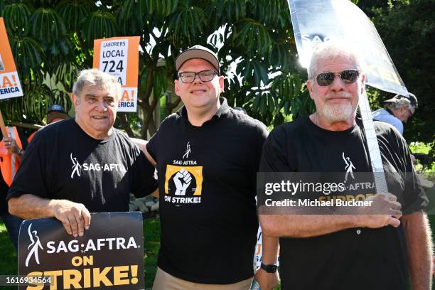 Dan Lauria, Duncan Crabtree-Ireland and Ron Perlman the SAG-AFTRA and WGA strike at Disney Studios on August 22, 2023 in Burbank, California.