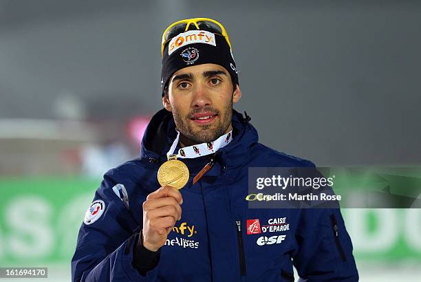 Martin Fourcade of France poses with the gold medal after the Men's 20km Individual during the IBU Biathlon World Championships at Vysocina Arena on...