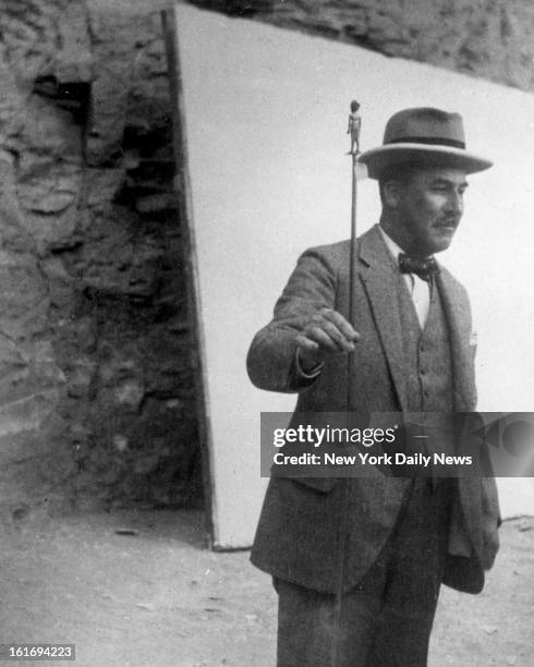 Howard Carter, King Tut Egyptian tomb explorer, with cane of Tutankhamen. First picture received in this country showing Howard Carter, Noted...