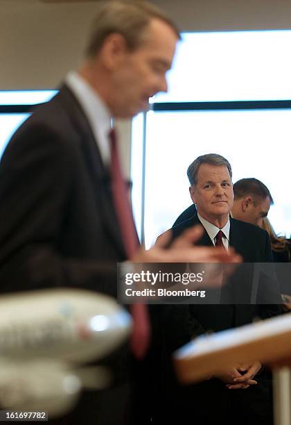 Doug Parker, chief executive officer of US Airways Group Inc., right, listens as Tom Horton, president and chief executive officer of AMR Corp.'s...