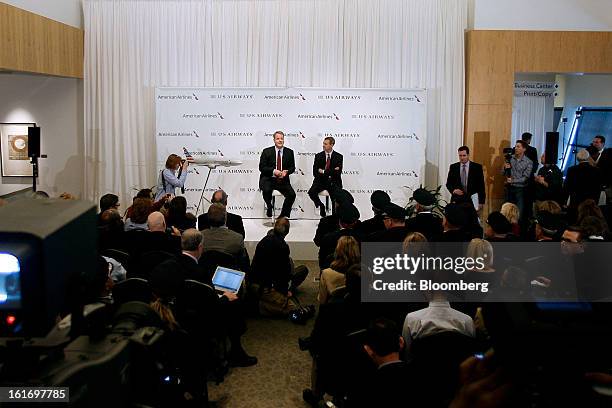 Doug Parker, chief executive officer of US Airways Group Inc., left, speaks while Tom Horton, president and chief executive officer of AMR Corp.'s...
