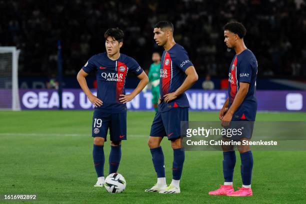 Lee Kang In of Paris Saint-Germain, Achraf Hakimi of Paris Saint-Germain and Warren Zaire Emery of Paris Saint-Germain look to shoot a free kick...
