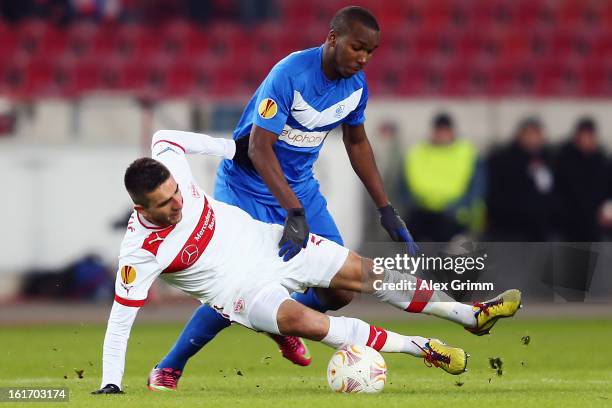 Vedad Ibisevic of Stuttgart is challenged by Khaleem Hyland of Genk during the UEFA Europa League Round of 32 first leg match between VfB Stuttgart...