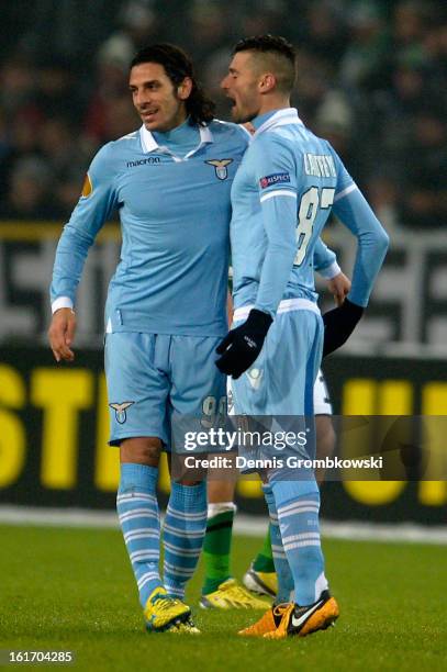 Sergio Flaccori of Lazio celebrates with teammate Antonio Candreva after scoring his team's first goal during the UEFA Europa League round of 32...