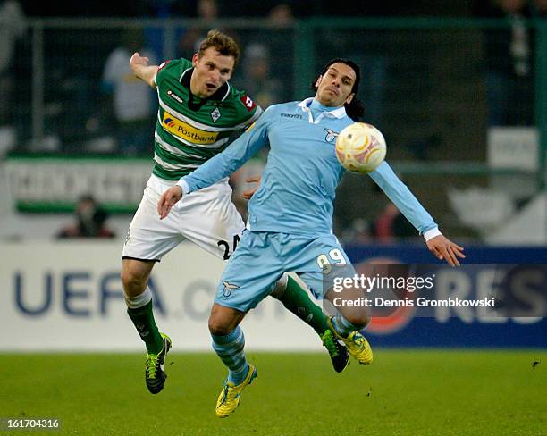 Tony Jantschke of Moenchengladbach and Sergio Floccari of Lazio battle for the ball during the UEFA Europa League round of 32 first leg match between...