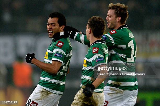 Juan Arango of Moenchengladbach celebrates with teammates after scoring his team's third goal during the UEFA Europa League round of 32 first leg...