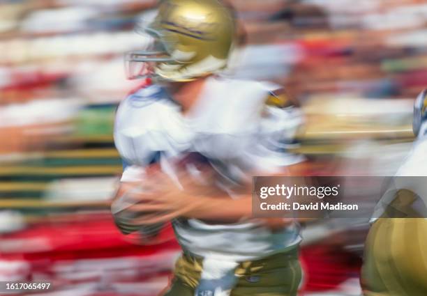 Cade McNown of the UCLA Bruins plays in a PAC-10 college football game against the Stanford Cardinal on October 21, 1995 at Stanford Stadium on the...