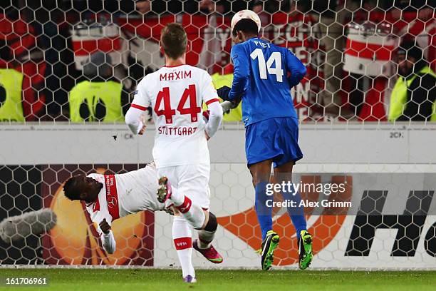 Glynor Plet of Genk scores his team's first goal against Arthur Boka and Alexandru Maxim of Stuttgart during the UEFA Europa League Round of 32 first...