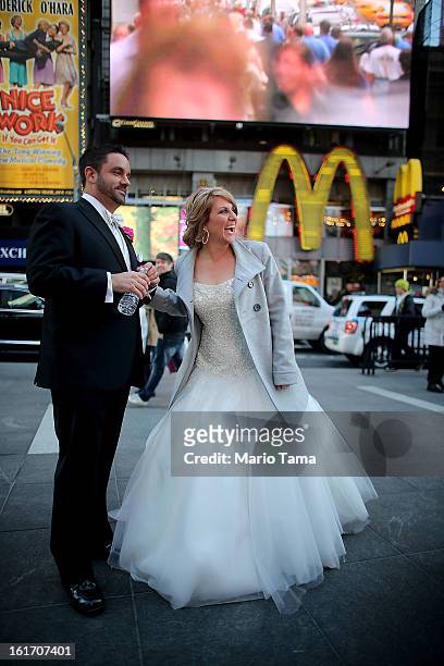 Newly married couple Brian Bondy and Melissa Cohn stand in Times Square on Valentine's Day on February 14, 2013 in New York City. Bondy proposed to...
