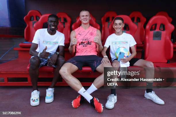 Erling Haaland of Manchester City poses for a photo with UEFA Foundation kids during a Manchester City Training Session ahead of the UEFA Super Cup...