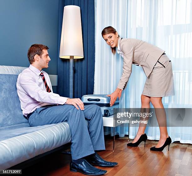 young couple in the hotel room - man waiting couch stock pictures, royalty-free photos & images