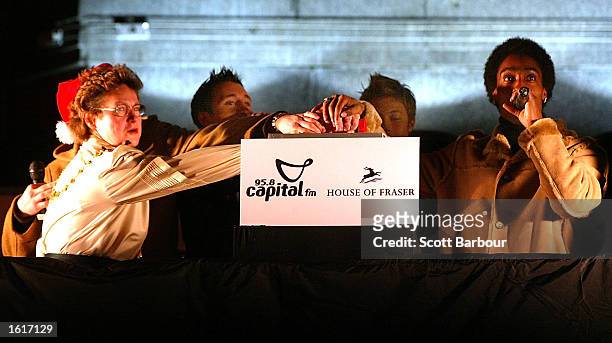Members of the UK boy-band Blue switch on the Oxford Street Christmas lights November 12, 2002 in London.