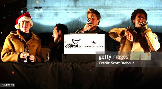 Members of the UK boy-band Blue switch on the Oxford Street Christmas lights November 12, 2002 in London.