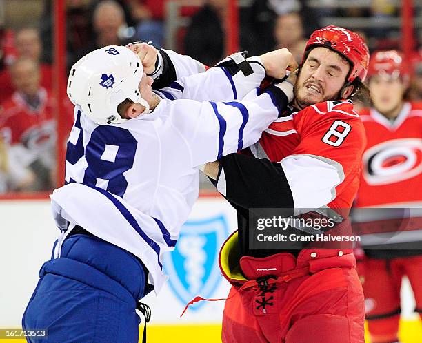 Colton Orr of the Toronto Maple fights with Kevin Westgarth of the Carolina Hurricanes during the first period at PNC Arena on February 14, 2013 in...