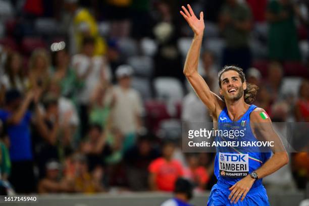First-placed Italy's Gianmarco Tamberi celebrates after winning in the men's high jump final during the World Athletics Championships at the National...