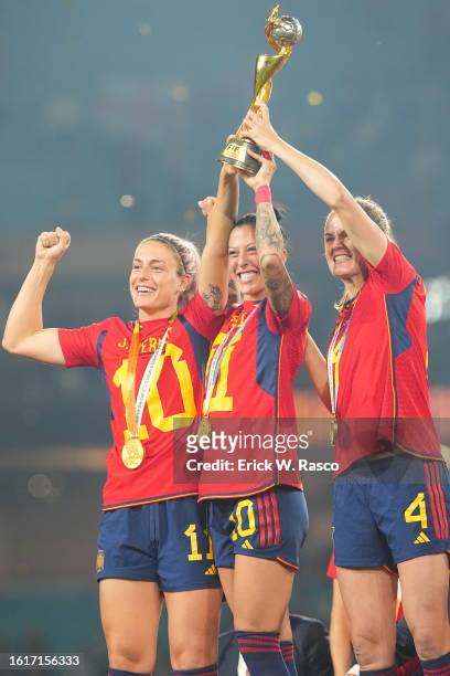 World Cup: Spain players Alexia Putellas, Jennifer Hermoso and Irene Paredes celebrate with the Golden Ball trophy following the Final match vs...