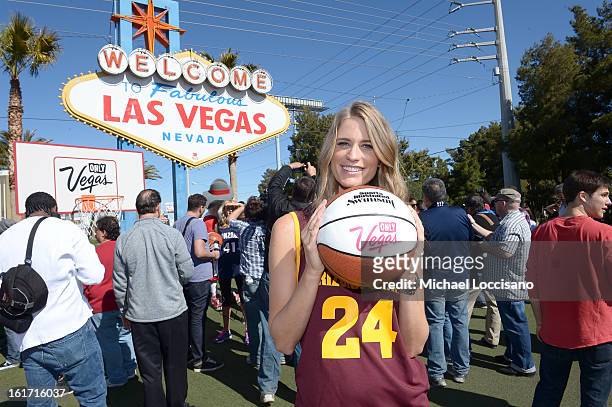 And Sports Illustrated Model Julie Henderson support the NCAA Basketball Conference Championship at the historic Las Vegas sign on February 14, 2013...