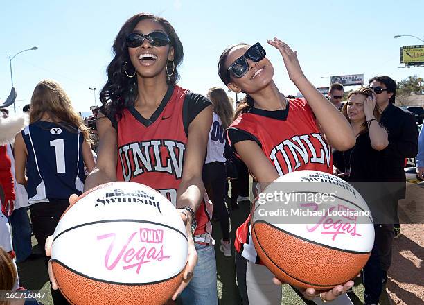 And Sports Illustrated Models Adaora and Ariel Meredith support the NCAA Basketball Conference Championship at the historic Las Vegas sign on...