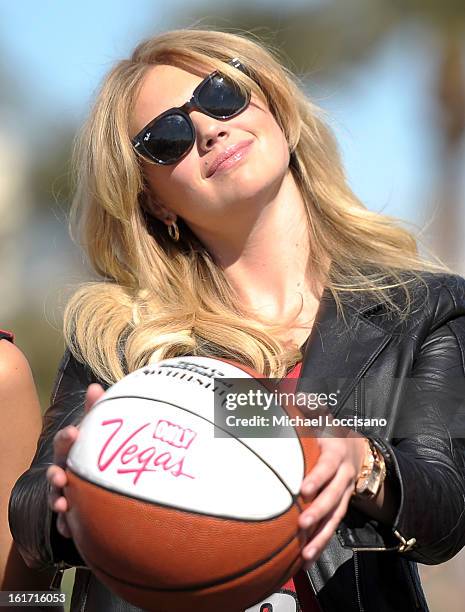 And Sports Illustrated Model Kate Upton support the NCAA Basketball Conference Championship at the historic Las Vegas sign on February 14, 2013 in...