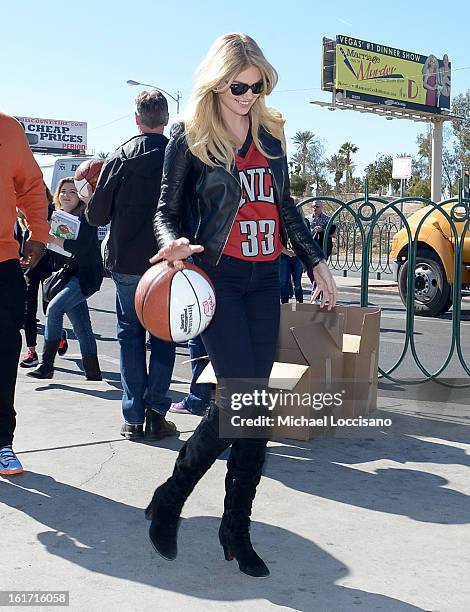 And Sports Illustrated Model Kate Upton support the NCAA Basketball Conference Championship at the historic Las Vegas sign on February 14, 2013 in...
