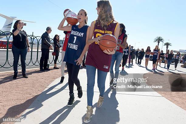 And Sports Illustrated Models Chrissy Teigen and Julie Henderson support the NCAA Basketball Conference Championship at the historic Las Vegas sign...