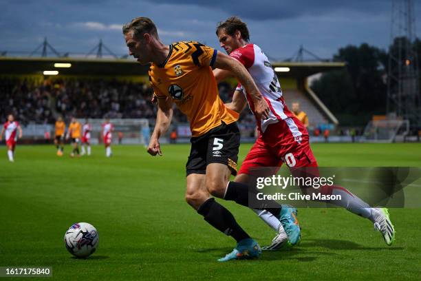 Michael Morrison of Cambridge United turns away from Aaron Pressley of Stevenage during the Sky Bet League One match between Cambridge United and...