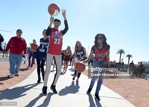And Sports Illustrated Models Ariel Meredith and Adaora support the NCAA Basketball Conference Championship at the historic Las Vegas sign on...