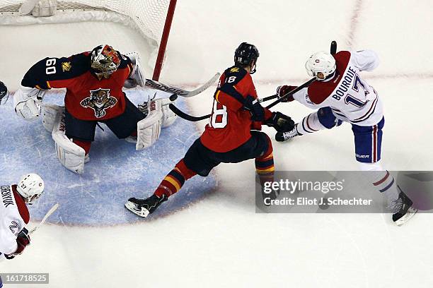 Rene Bourque of the Montreal Canadiens shoots and scores the game-winning goal in overtime against Goaltender Jose Theodore and Shawn Matthias of the...