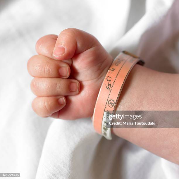 baby hand - hospital identification bracelet stock pictures, royalty-free photos & images