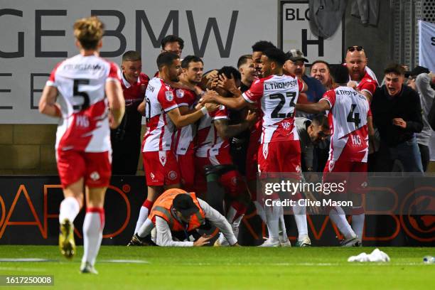 Jamie Reid of Stevenage celebrates with teammates after scoring the team's second goal during the Sky Bet League One match between Cambridge United...