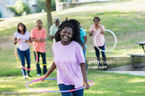 teenage african-american girl, family, hooping - hooping stock pictures, royalty-free photos & images