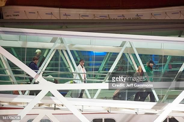 Passengers walk down the terminal from the crippled cruise liner Carnival Triumph February 14, 2013 in Mobile, Alabama. An engine fire on February 10...
