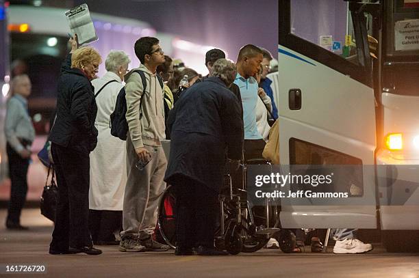 Passengers wait to leave by bus from the crippled cruise liner Carnival Triumph February 14, 2013 in Mobile, Alabama. An engine fire on February 10...