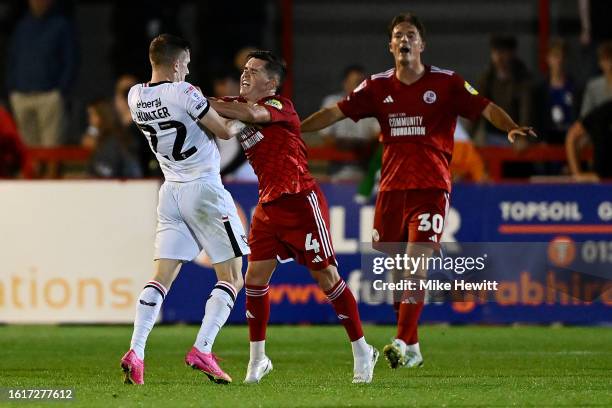 Ashley Hunter of MK Dons and Liam Kelly of Crawley Town clash during the Sky Bet League Two match between Crawley Town and Milton Keynes Dons at...