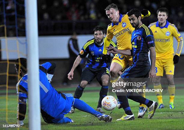 Fenerbahce SK's goalkeeper Volkan Demirel and players, Egemen Kokmaz and Cristian vie with Bate Borisov's Vitali Rodionov during their round of 32...