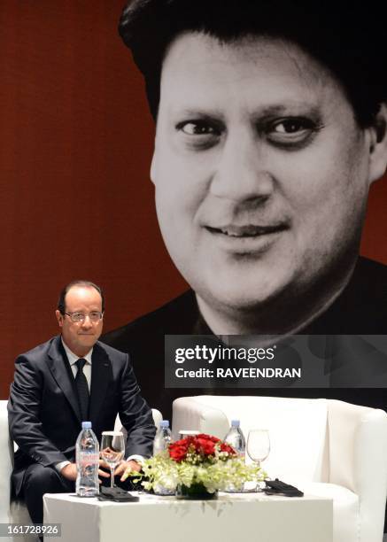 French President Francois Hollande sits before presenting France's highest civilian award, the Legion of Honour, to Indian Nobel laureate Amartya Sen...