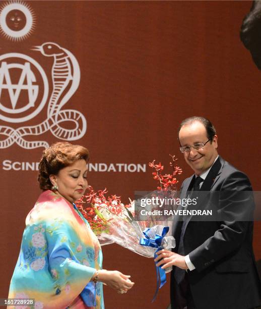 French President Francois Hollande is greeted by Madhavi Raje Scindia , wife of the former Minister and Congress leader, Madhavrao Scindia during a...