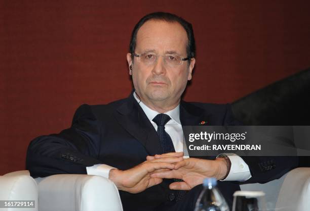 French President Francois Hollande looks on before giving a speech during a Madhavrao Scindia Foundation function in New Delhi on February 15, 2013....