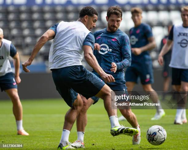 Ben Cabango and Joe Allen of Swansea City battle for the ball during the Swansea City Training Session at The Swansea.com Stadium on August 22, 2023...
