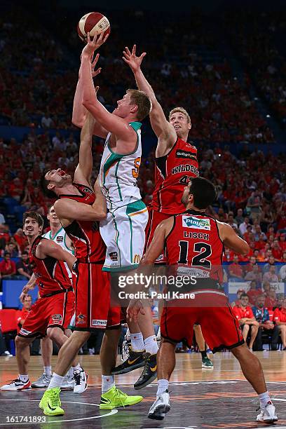 Luke Nevill of the Crocodiles takes a shot against Jeremiah Trueman and Shawn Redhage of the Wildcats during the round 19 NBL match between the Perth...