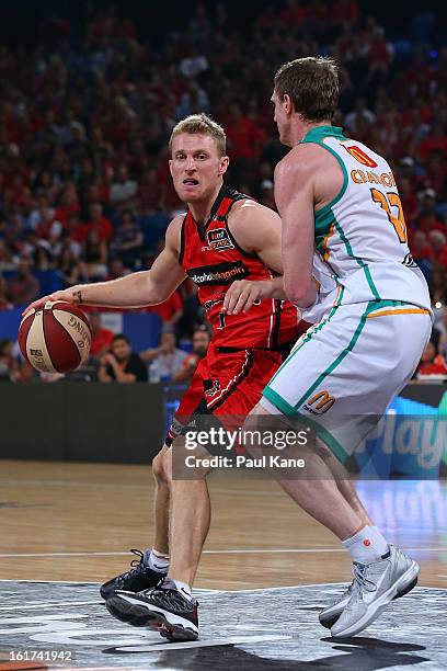 Rhys Carter of the Wildcats looks to layup against Peter Crawford of the Wildcats during the round 19 NBL match between the Perth Wildcats and the...