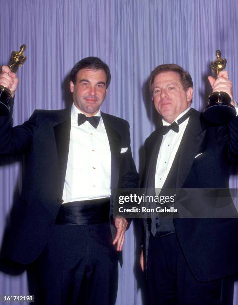 Director Oliver Stone and Producer Arnold Kopelson attend the 59th Annual Academy Awards on March 30, 1987 at Dorothy Chandler Pavilion in Los...